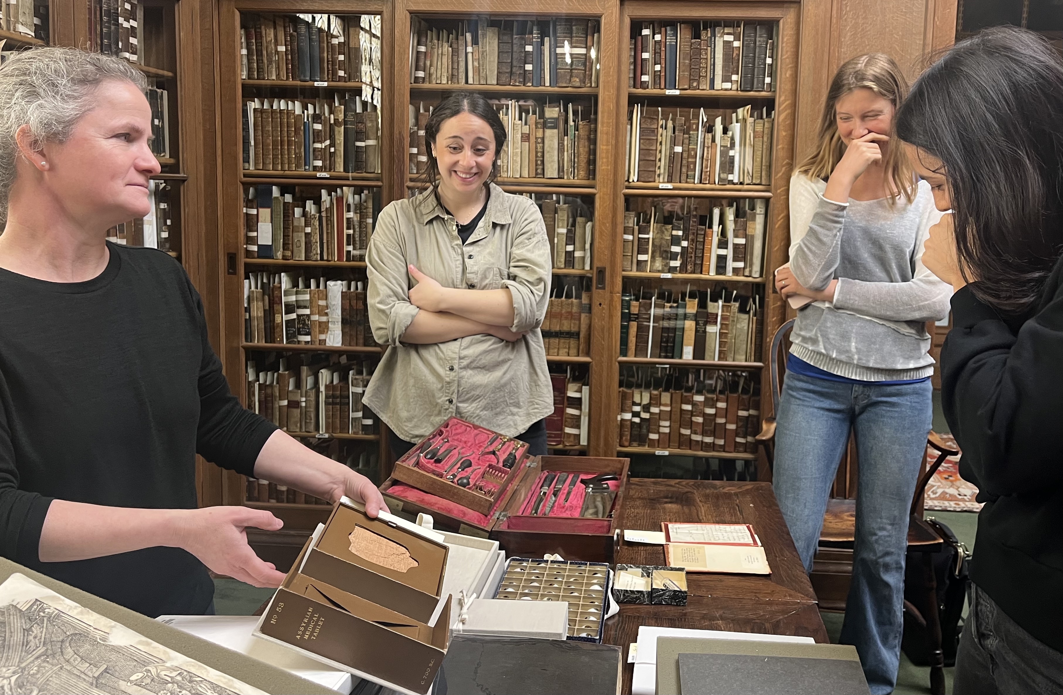 Head Librarian Dr. Hague-Yearl at the Osler Library of McGill University showing an almost 3000 year old medical tablet in the Osler collection to staff of the JPL Archives.
